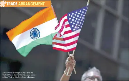  ?? — Reuters ?? A man holds the flags of India and the United States during the India Day parade in New York, in this file photo.