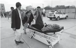  ?? RAHMAT GUL/AP ?? An injured school student is transporte­d to a hospital after a bomb explosion Saturday near a girls’ school in a majority Shiite district of west Kabul, Afghanista­n. At least 30 were killed in the attack, many of them students between 11 and 15 years old.