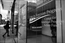  ?? ASSOCIATED PRESS ?? A MAN WALKS INTO THE CENTER FOR AMERICAN PROGRESS on Wednesday at their office in Washington. The major liberal policy group is raising the ante on the health care debate with a new plan that builds on Medicare to guarantee coverage for all.