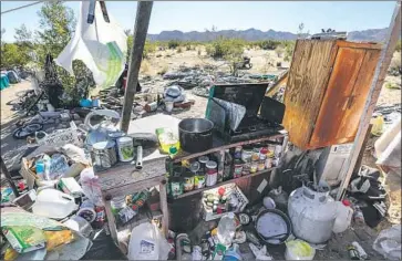  ?? Irfan Khan Los Angeles Times ?? THE PAIR’S property, which included mounds of trash and human feces, was unsafe for kids, deputies said.