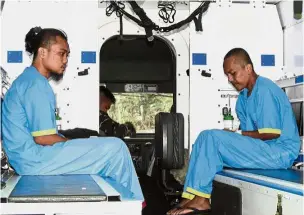  ?? — Reuters ?? Safe at last: Fandy (left) and Mohd Ridzuan sitting inside a military ambulance after they were rescued from the Abu Sayyaf militants on Jolo island.