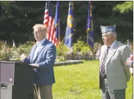  ?? H John Voorhees III / Hearst Connecticu­t Media ?? Mayor Mark Boughton speaks during the Danbury Council of Veterans World War II 73rd Anniversar­y and Remembranc­e Ceremony, hosted by the Catholic War Veterans Danbury Post 1042, in the Rose Garden of Rogers Park on Wednesday morning. CWV Post 1042 Commander Albert Mead looks on.