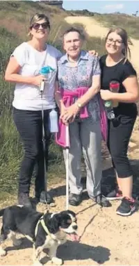  ??  ?? Dorothea Crompton (centre) at the top of Holcombe Hill with Julie Ward (left), director of operations at Hewlett Court,with Suzzy the dog and Rachel Cookson, team leader