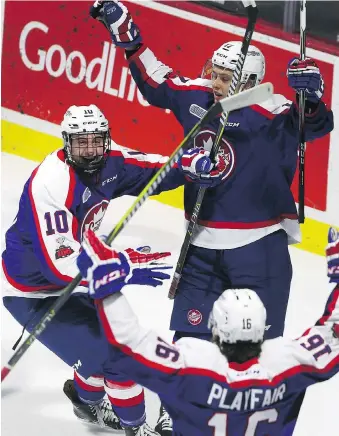  ?? DAN JANISSE ?? Windsor’s Jordan Frasca, left, celebrates his first OHL goal with teammates Igor Larionov, top, and Chris Playfair during Sunday’s 4-2 loss to the Saginaw Spirit at the WFCU Centre.