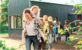  ??  ?? Clare Dunne (front), carrying Ruby Rose O’Hara, in a scene from “Herself”