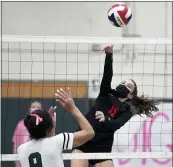  ?? OWEN MCCUE - MEDIANEWS GROUP ?? Boyertown’s Allison Pioli (15) goes for a kill as Methacton’s Bianca Robinson (9) watches on Monday.