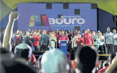  ?? AFP ?? Venezuelan President Nicolas Maduro, centre, speaks to supporters after the National Electoral Council announced him as the winner on Sunday night.