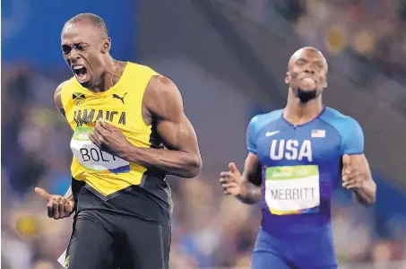  ?? DAVID J. PHILLIP/ASSOCIATED PRESS ?? Usain Bolt, left, celebrates after winning the gold medal in the 200 meters Thursday in Rio. He finished in 19.78 seconds, capturing the eighth gold medal of his career.