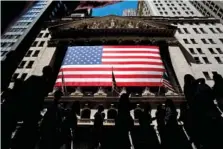  ?? AP PHOTO/JULIA NIKHINSON ?? People walk past the New York Stock Exchange in 2022 in New York.