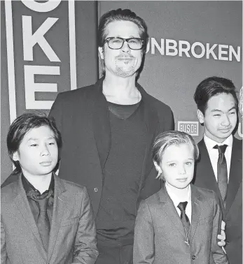  ?? JASON LAVERIS, FILMMAGIC ?? Brad Pitt with his children Pax, Shiloh and Maddox at the Unbroken premiere in 2014.