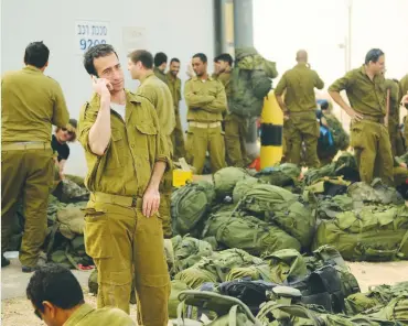  ?? (Wikimedia Commons) ?? IDF RESERVISTS gather at a staging area before entering the Gaza Strip during Operation Pillar of Defense in November 2012.