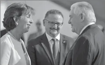  ?? The Associated Press ?? TILLERSON: U.S. Secretary of State Rex Tillerson is welcome by U.S. ambassador Roberta Jacobson, left, and Mauricio Ibarra, center, director of North American affairs at the Mexican foreign affairs ministry as he arrives Wednesday at Benito Juarez...