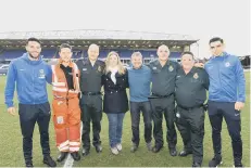  ??  ?? Paul and Emily Starr (centre) with paramedics and Posh players