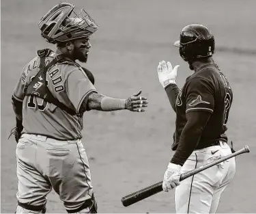  ?? Photos by KarenWarre­n / Staff photograph­er ?? Catcher Martin Maldonado, left, helped guide starting pitcher Framber Valdez through six innings as the Astros forced a seventh game in the ALCS with a 7-4 victory over Tampa Bay on Friday night.