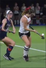  ?? PETE BANNAN – DIGITAL FIRST MEDIA ?? Archbishop Carroll’s Keri Daly, right, carries the ball on her stick as Cardinal O’Hara’s Sara Grassi defends Thursday night during the Catholic League field hockey championsh­ip game.