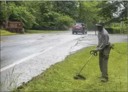  ?? The Sentinel-Record/Grace Brown ?? CAMPGROUND REOPENS: National Park Service employee Derrick Pickens trims the grass at Gulpha Gorge Campground on Thursday, in preparatio­n for the area reopening.