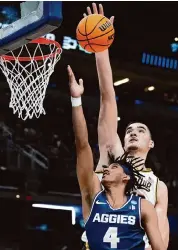  ?? Dylan Buell/Getty Images ?? Purdue star Zach Edey, rear, dominated Utah State with 23 points and 14 rebounds in Sunday’s rout.