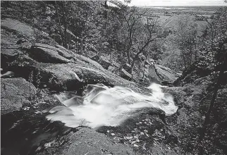  ??  ?? Luskville Falls with flat Ottawa Valley plain and Ottawa River below. The rich soil supports food industries whose work will be available for sampling at the Pontiac fair.