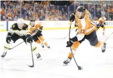  ?? MATT SLOCUM/AP ?? The Flyers’ Kevin Hayes, right, takes a shot during a game against Boston on March 10, 2020, in Philadelph­ia. The NHL season was halted the next day and the Flyers did not play another game until July.