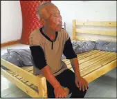  ?? JONATHAN KAIMAN/LOS ANGELES TIMES/TNS ?? Ma Jixiang sits outside his room at the Baishi Town Central Elderly Home in Hunan Province, China. Jixiang in 2009 disappeare­d from his home and was thought to have died in a 2012 minivan crash, but he resurfaced last year.