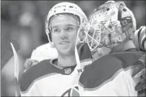  ?? David Zalubowski ?? The Associated Press Oilers center Connor Mcdavid and goalie Cam Talbot celebrate Edmonton’s 4-2 win over the Avalanche on Sunday at the Pepsi Center. Mcdavid scored three goals.