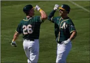  ?? MATT YORK — THE ASSOCIATED PRESS ?? Oakland Athletics’ Matt Olson greets Matt Chapman (26) after hitting a solo home run against the Los Angeles Angels during the third inning of a spring training baseball game, Friday in Mesa, Ariz.