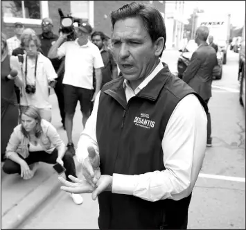  ?? CHARLIE NEIBERGALL / ASSOCIATED PRESS ?? Florida Gov. Ron Desantis speaks to reporters Thursday following a meet-and-greet at the Hotel Charitone in Chariton, Iowa.