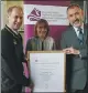  ??  ?? The Earl hands over a certificat­e to Nicola Smith and Iain Morrison to mark the University of the Highlands and Islands on becoming a licensed DofE centre.