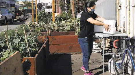  ?? Photos by Yalonda M. James / The Chronicle ?? Joyce Tang of Berkeley’s Bake Sum delivers boxes of pastries to Magnolia Mini Mart, an Oakland specialty food store and incubator.