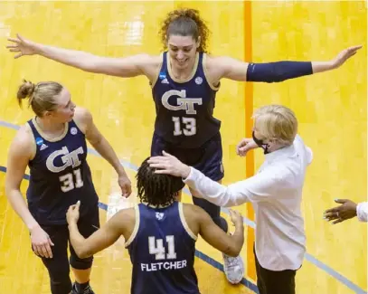  ?? Associated Press photos ?? Lorela Cubaj (13), from Italy, led Georgia Tech had 21 points and 12 rebounds in a 73-56 win against West Virginia. Lotta-Maj Lahtinen (31) is from Finland; also pictured: Kierra Fletcher (41) and coach Nell Fortner.