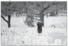  ?? U.S. Army/RACHEL LARUE ?? Staff Sgt. J. Martin “Marty” Bishop
of Jonesboro, a member of the U.S. Army Band known as “Pershing’s Own,” plays taps earlier this year during a graveside service at Arlington National Cemetery in Virginia.