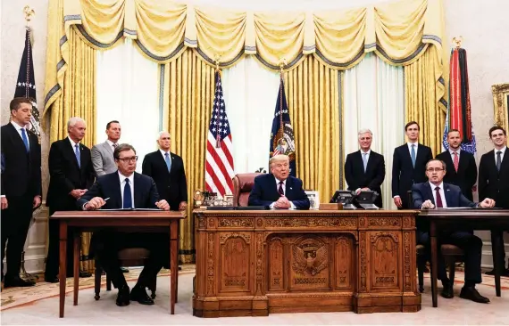  ?? AFP ?? Serbia’s President Aleksandar Vucic, US President Donald Trump and the Prime Minister of
Kosovo Avdullah Hoti at the signing of the deal in the White House, above; a rally for independen­ce in the Kosovan capital, Pristina, in 2007, right.