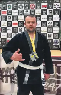  ??  ?? Paul Mcghee with his BJJ Scottish Open silver medal.