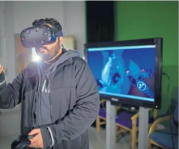  ??  ?? TOP OF THE LEAGUE: A student uses VR technology at Abertay University.