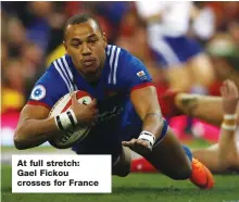  ??  ?? At full stretch: Gael Fickou crosses for France
