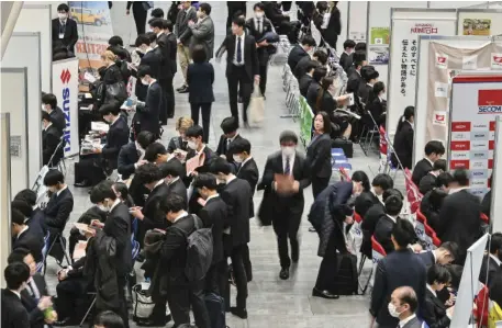  ?? RICHARD A. BROOKS/AGENCE FRANCE-PRESSE ?? UNIVERSITY students, scheduled to graduate in 2025, visit the booths of some 250 companies and organizati­ons as they attend an employment seminar at the Tokyo Internatio­nal Forum in downtown Tokyo.