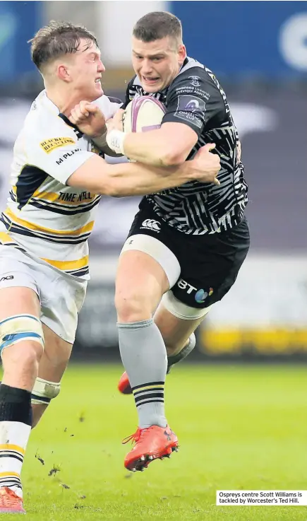  ??  ?? Ospreys centre Scott Williams is tackled by Worcester’s Ted Hill.