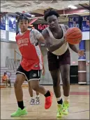  ?? Photos by Louriann Mardo-Zayat / lmzartwork­s.com ?? The Woonsocket boys basketball team couldn’t overcome an early deficit to East Providence in Wednesday night’s MSC Summer League final.