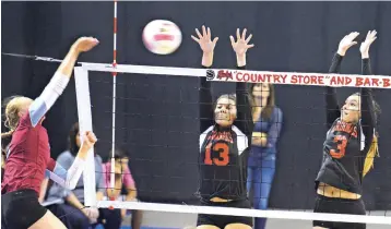  ?? NEW MEXICAN FILE PHOTOS ?? From left, Sandia Prep’s Camryn Nelson spikes the ball as Las Vegas Robertson’s Brandee Fulgenzi and Tessa Ortiz defend during last year’s Class 4A volleyball championsh­ip in Rio Rancho. Robertson was swept in three games, losing the state title to Sandia Prep.