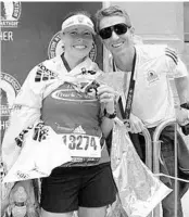  ?? CONTRIBUTE­D ?? Cheryl Sobering, left, and her now husband pose after she ran her first Boston Marathon in 2018.