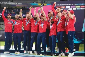  ?? ?? England players celebrate with the winners trophy after their win against Pakistan in the final of the T20 World Cup cricket at the Melbourne Cricket Ground in Melbourne, Australia. (AP)