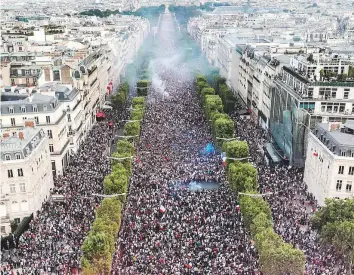  ?? AFP ?? This picture taken from the top of the Arc de Triomphe on Sunday shows people celebratin­g France’s victory in the final on the Champs-Elysees avenue in Paris.
