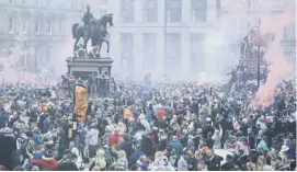  ??  ?? 0 Rangers fans celebrate winning the title at George Square in Glasgow