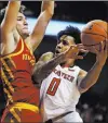  ?? Brad Tollefson The Associated Press ?? Iowa State’s George Conditt IV blocks Texas Tech’s Kyler Edwards’ path to the basket Wednesday.