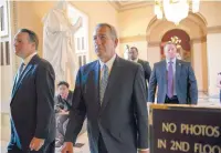  ?? J. SCOTT APPLEWHITE/THE ASSOCIATED PRESS ?? House Speaker John Boehner, center, walks to the House chamber at the Capitol on Friday evening. His deal for three weeks of Homeland Security funding was torpedoed in the House.