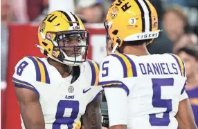  ?? JOHN DAVID MERCER/USA TODAY SPORTS ?? LSU’S Malik Nabers, left, celebrates his touchdown against Alabama with quarterbac­k Jayden Daniels last season.