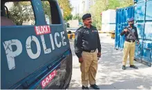  ?? AFP ?? Police stand guard near the French Consulate building to beef up security following a protest by Tehreek-e-Labbaik Pakistan (TLP), in Karachi yesterday.