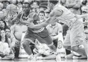  ??  ?? Indiana's Victor Oladipo (left) grabs a loose ball away from Ohio State's Lenzelle Smith on Sunday. JAY LAPRETE/AP