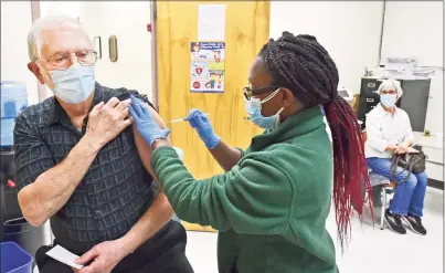  ?? Peter Hvizdak / Hearst Connecticu­t Media ?? William Stark, 72, of Wallingfor­d, gets vaccinated by nurse Leshawna Murrell at the New Haven Public Health
Department Friday. At top, Patricia Stark, 69, gets the vaccine from nurse Maxine Jones Singleton.