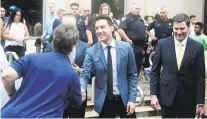  ?? JAMES NIELSEN/HOUSTON CHRONICLE VIA AP ?? David Daleiden, center, speaks with supporters Tuesday in Houston.